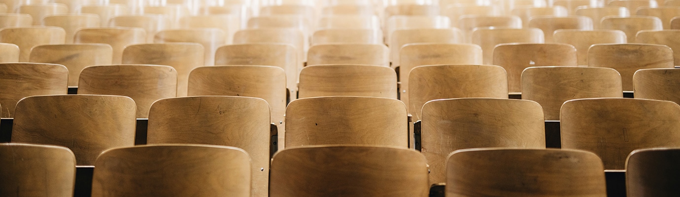 Empty rows of chairs in a large event hall